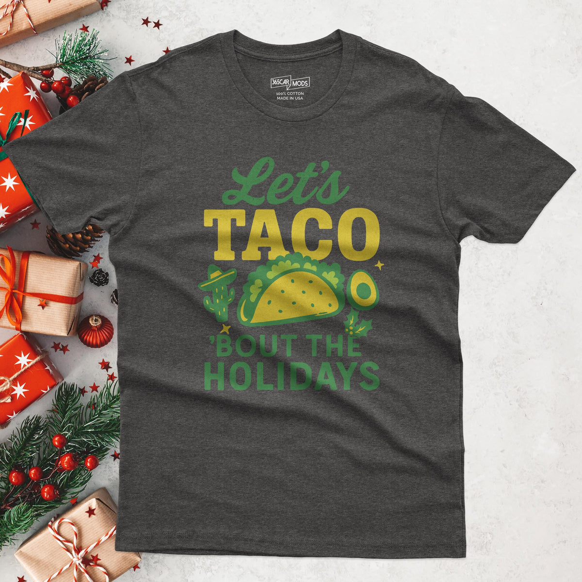 Dark gray t-shirt with the text Let's TACO 'Bout the Holidays in green and yellow, with a taco, avocado and cactus.