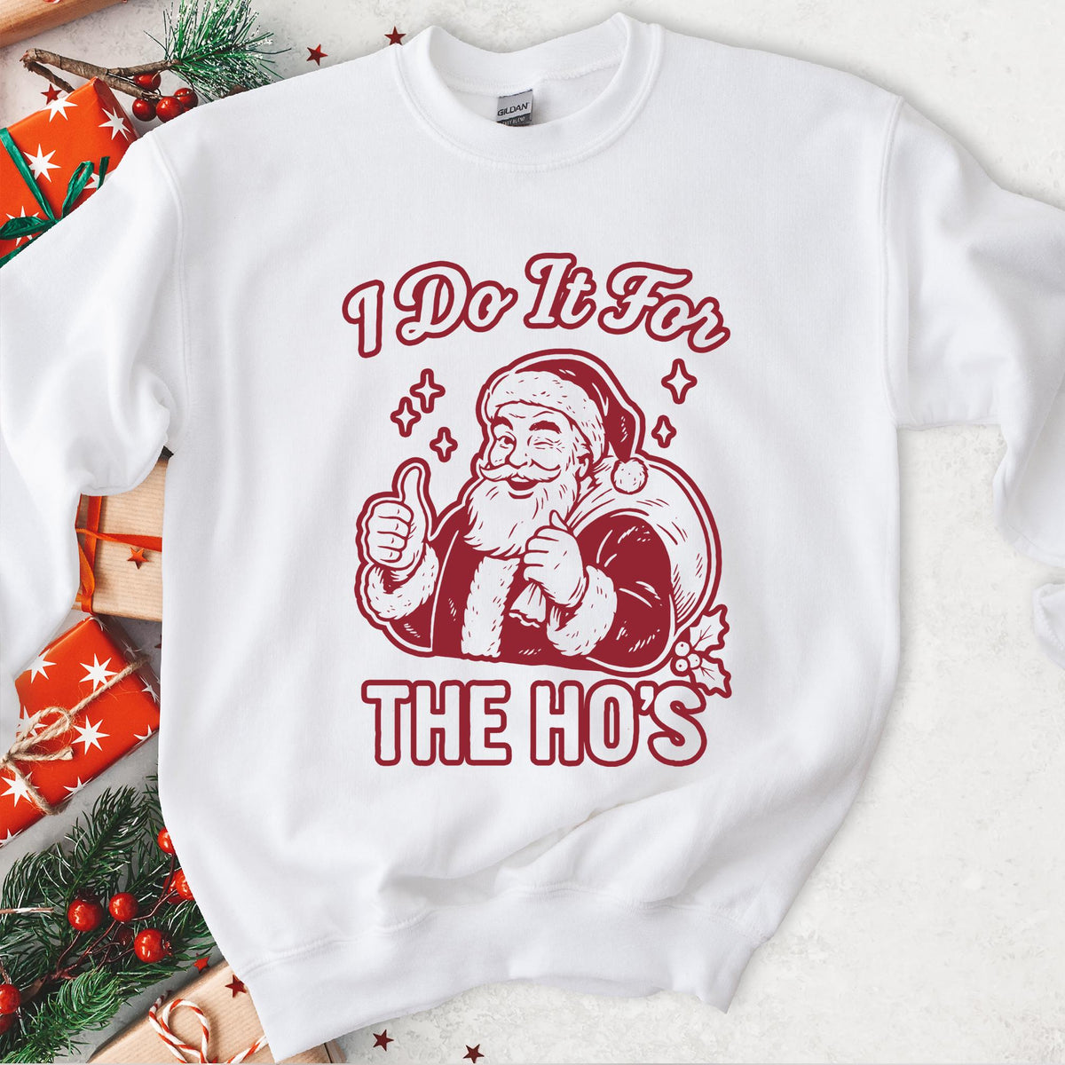 White sweatshirt with an I Do It for the Ho's print: a grinning Santa with his gift sack giving a thumbs up