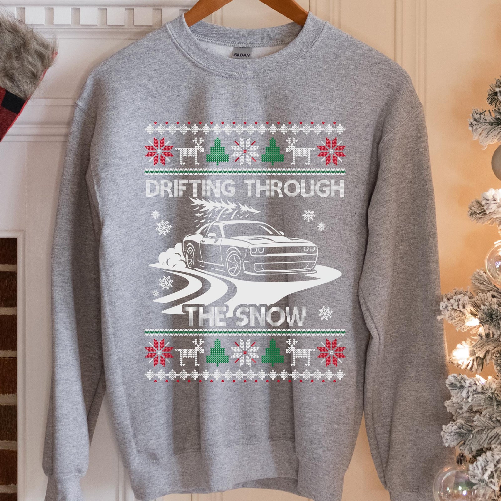 Sport Grey sweatshirt with a Drifting Through the Snow ugly Christmas print: a widebody muscle coupe with a tree on the roof drifting through the snow
