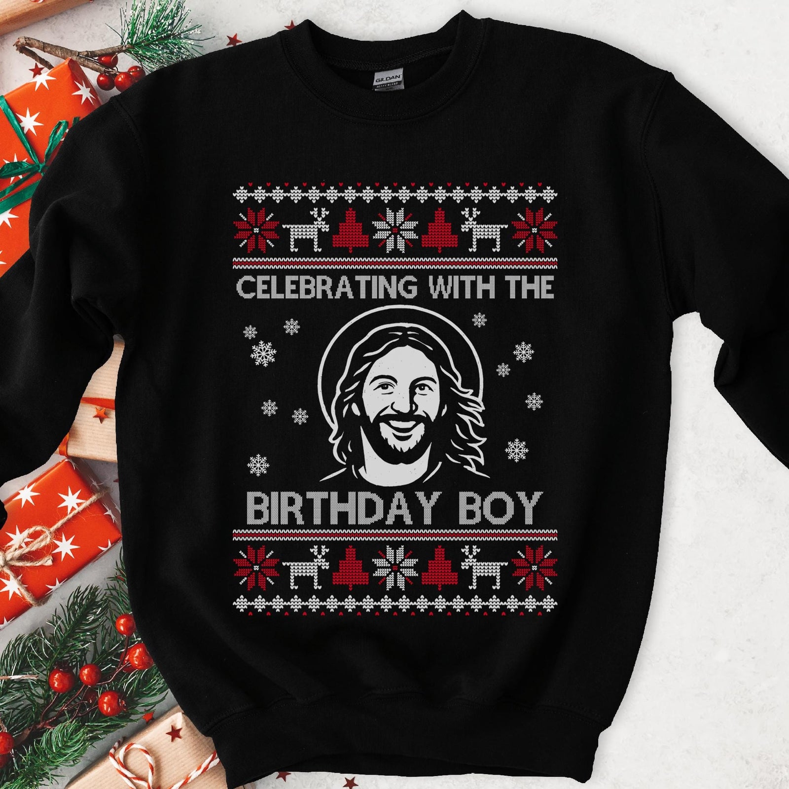 Dark sweatshirt with red and white knit borders and smiling Jesus with halo, text Celebrating With The Birthday Boy