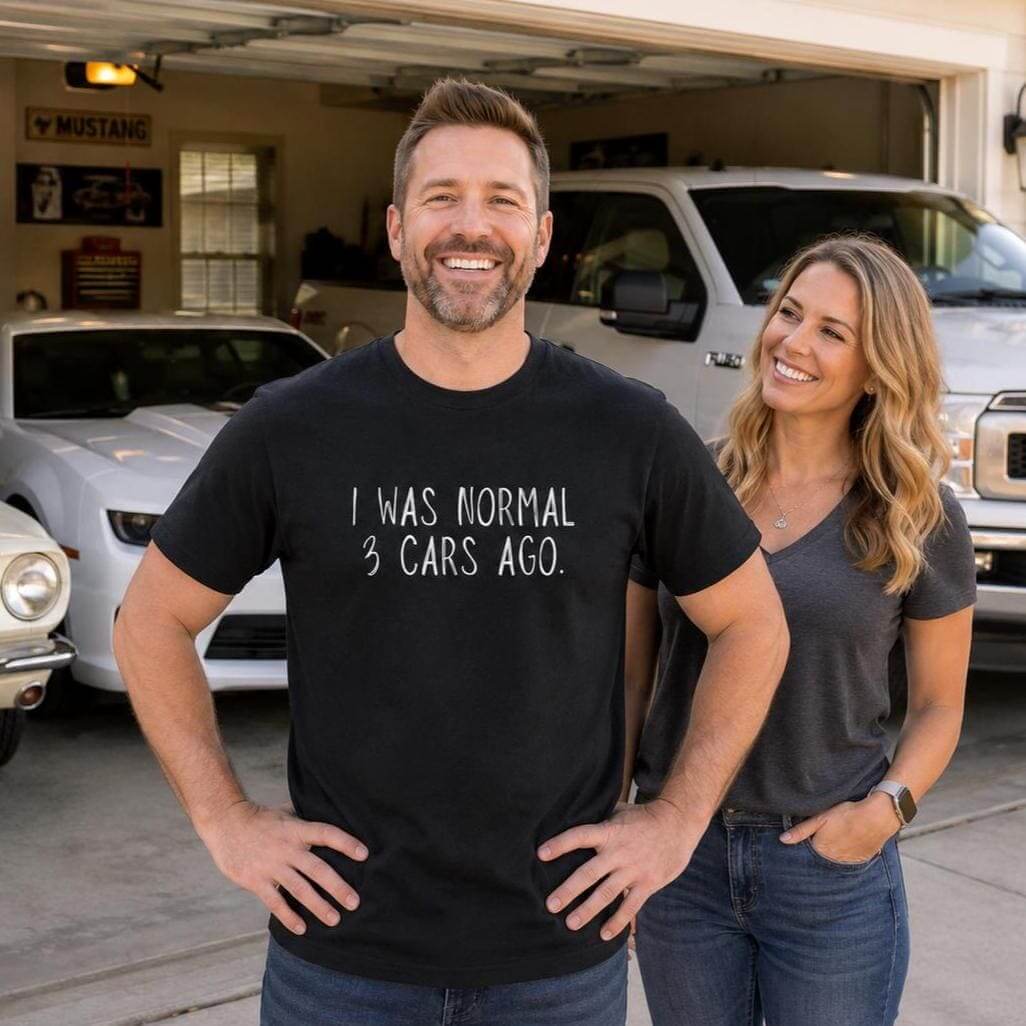 A black short-sleeved t-shirt featuring the white text "I WAS NORMAL 3 CARS AGO." printed on the front.
