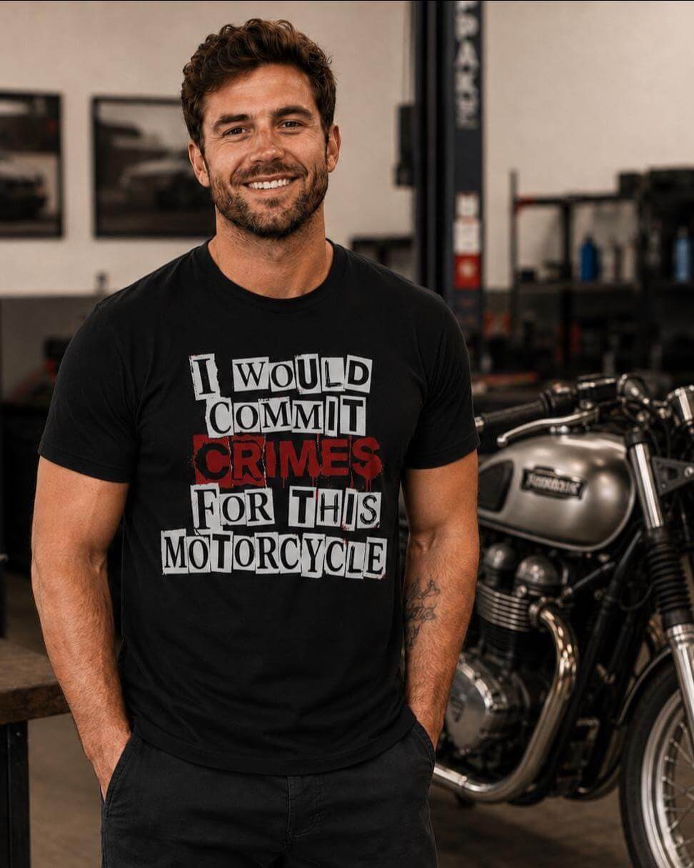 A black short-sleeved t-shirt featuring white block lettering that reads I WOULD COMMIT CRIMES FOR THIS MOTORCYCLE, with the word CRIMES printed in a distressed red font. The shirt has a crew neckline and a standard fit.