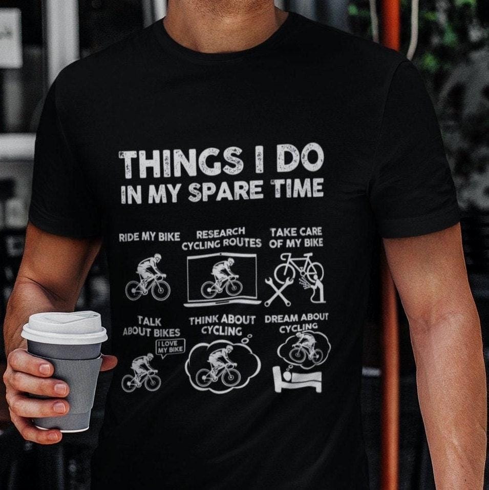Man holding a coffee cup in the black Things I Do in My Spare Time cycling t-shirt