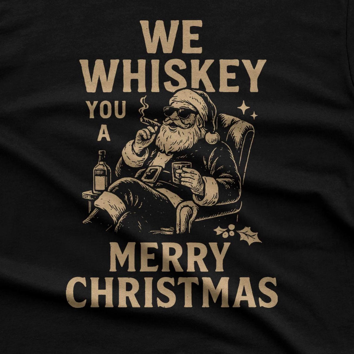 A black t-shirt featuring a tan graphic of Santa Claus wearing sunglasses, sitting in a chair while smoking a cigar and holding a glass of whiskey.
