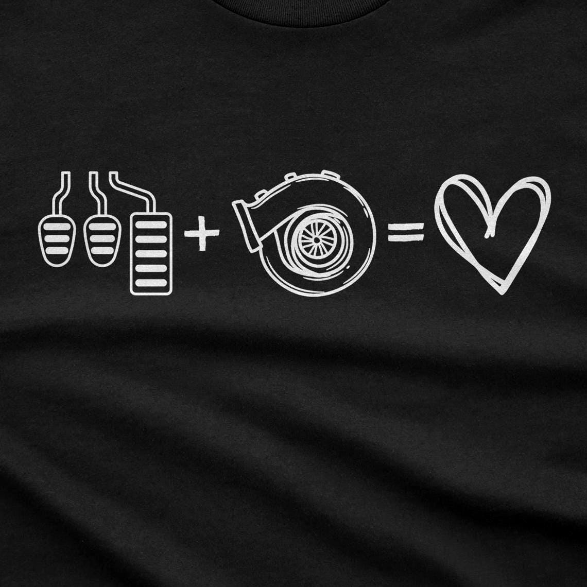 Close-up of the three pedals plus turbo equals heart line-art print on a black tee