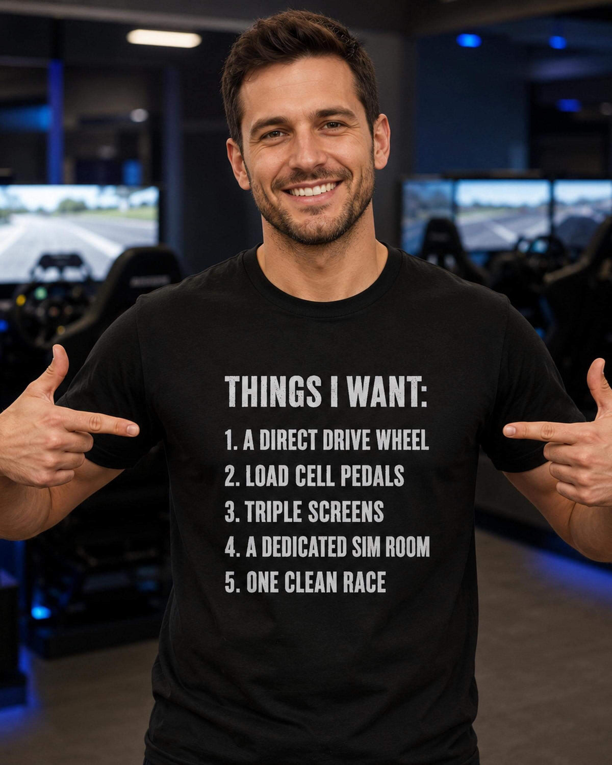 A black short-sleeved t-shirt featuring white text that reads: THINGS I WANT: 1. A DIRECT DRIVE WHEEL 2. LOAD CELL PEDALS 3. TRIPLE SCREENS 4. A DEDICATED SIM ROOM 5. ONE CLEAN RACE.