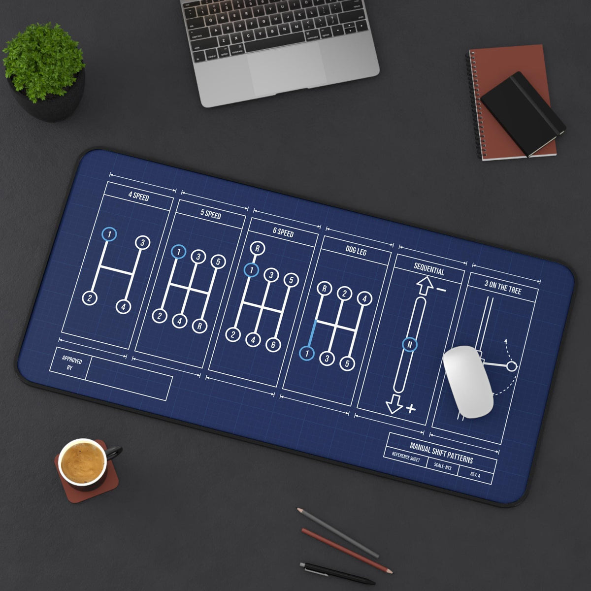 Extended manual shift patterns desk mat, top view on a dark desk