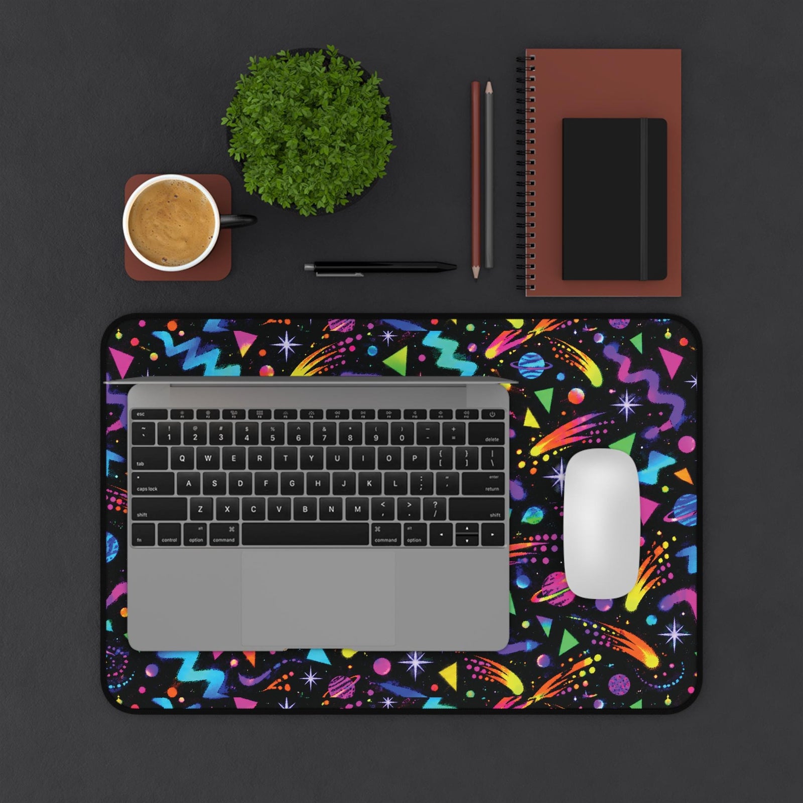 Arcade carpet desk mat under a laptop and mouse, top view