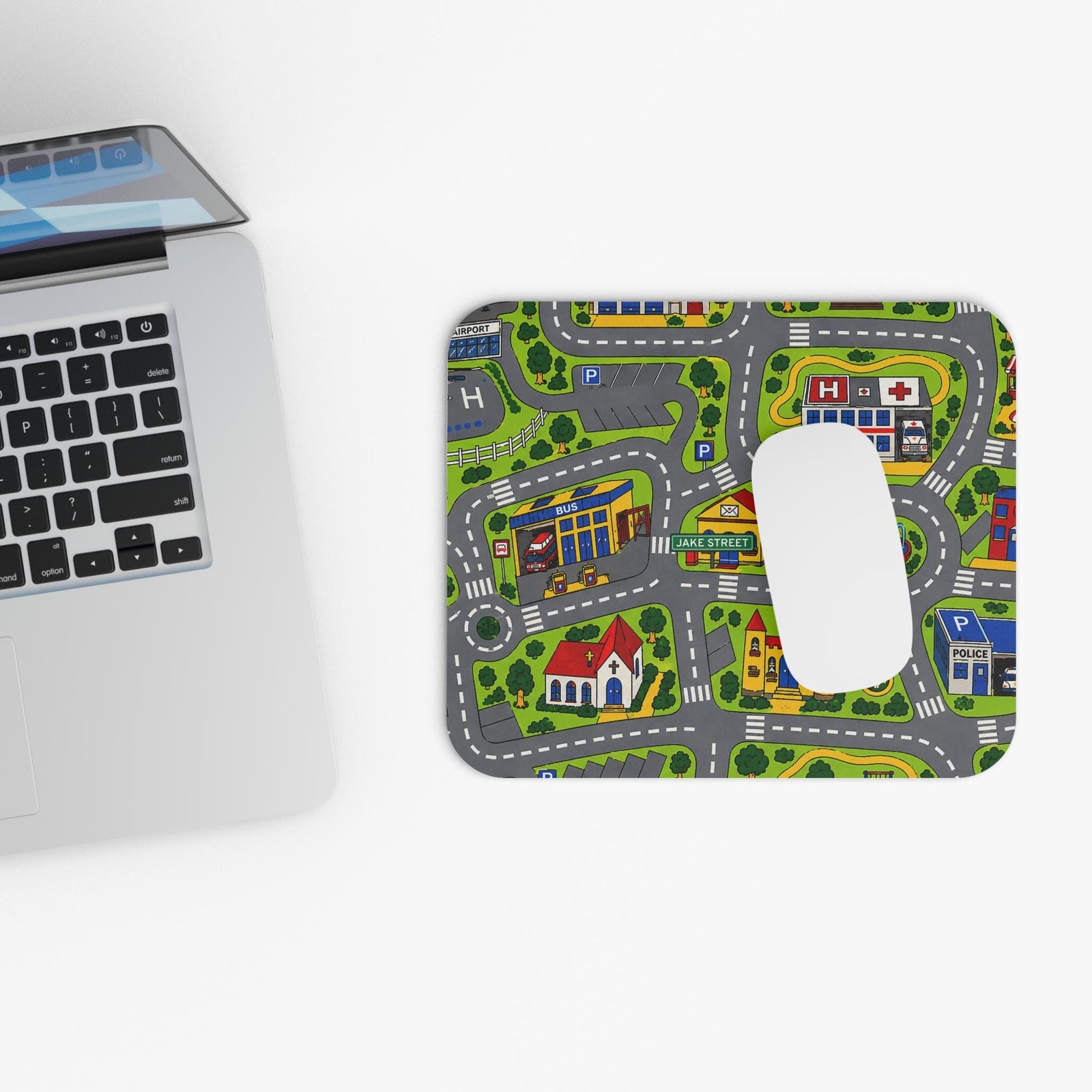Retro road rug mouse pad next to a laptop, top view