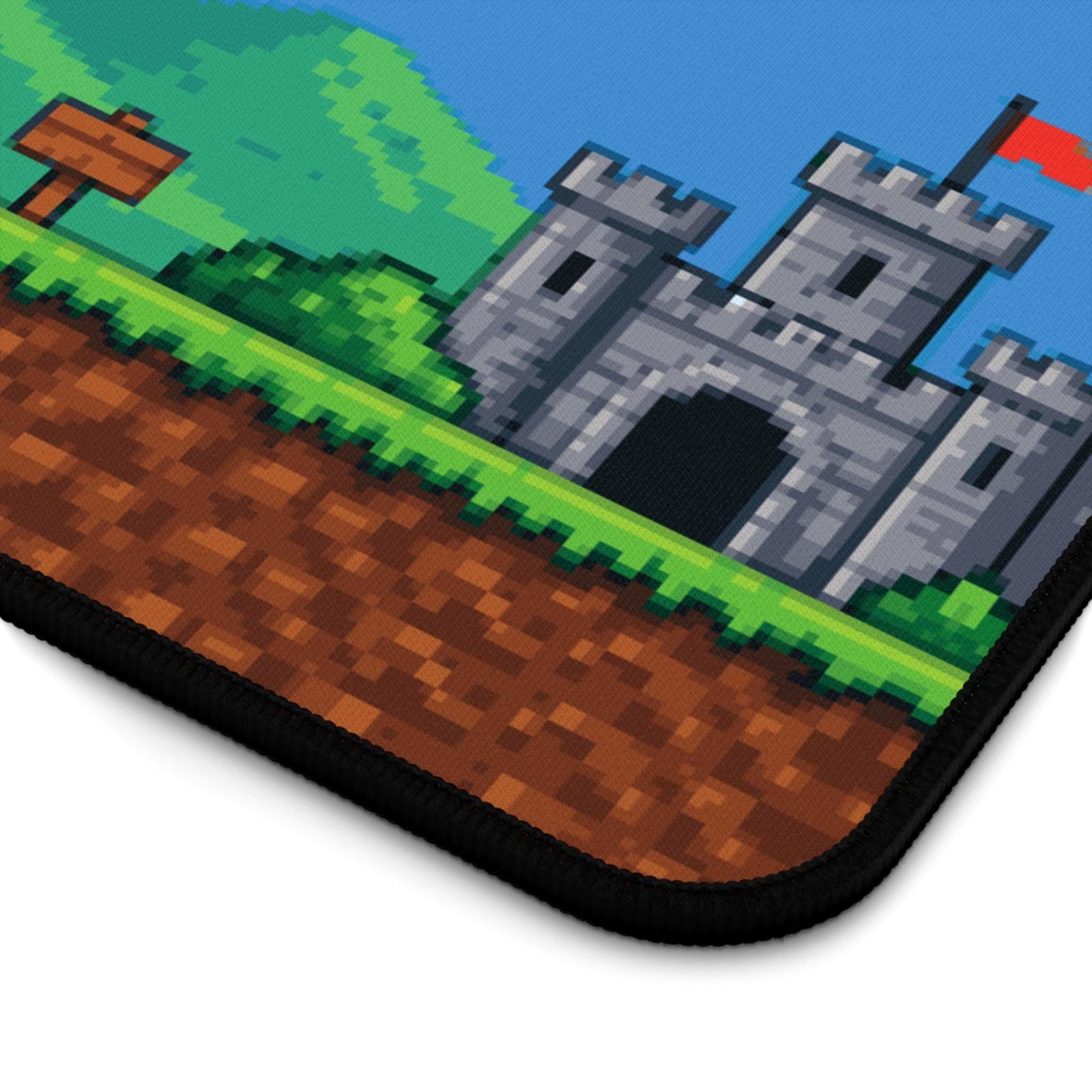 Close-up of the pixel art castle and the stitched edge of the desk mat