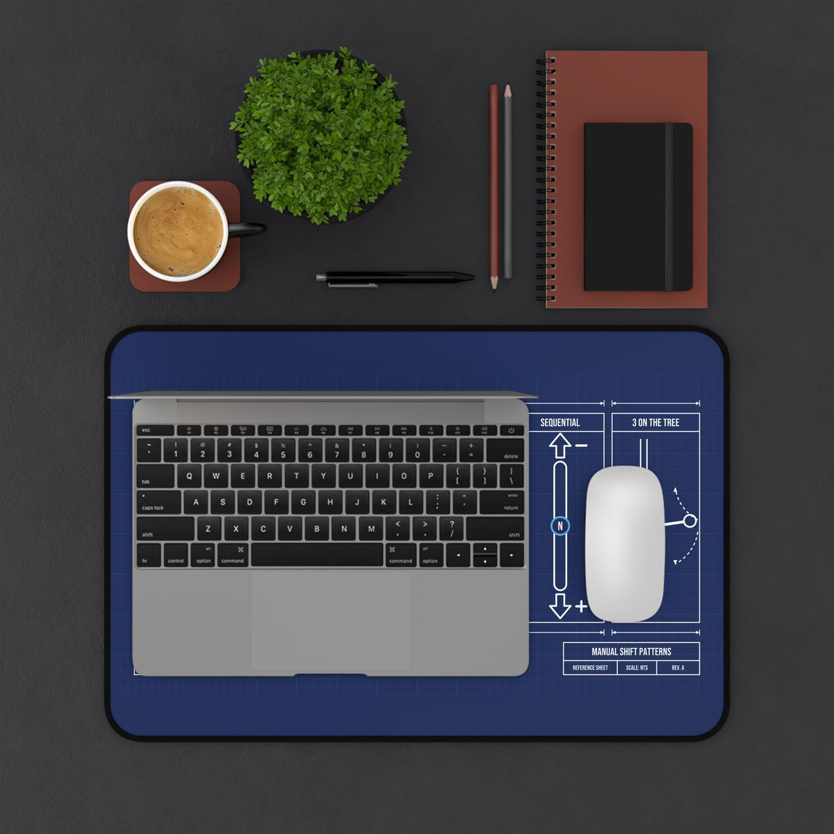 Shift patterns desk mat under a laptop and mouse, top view