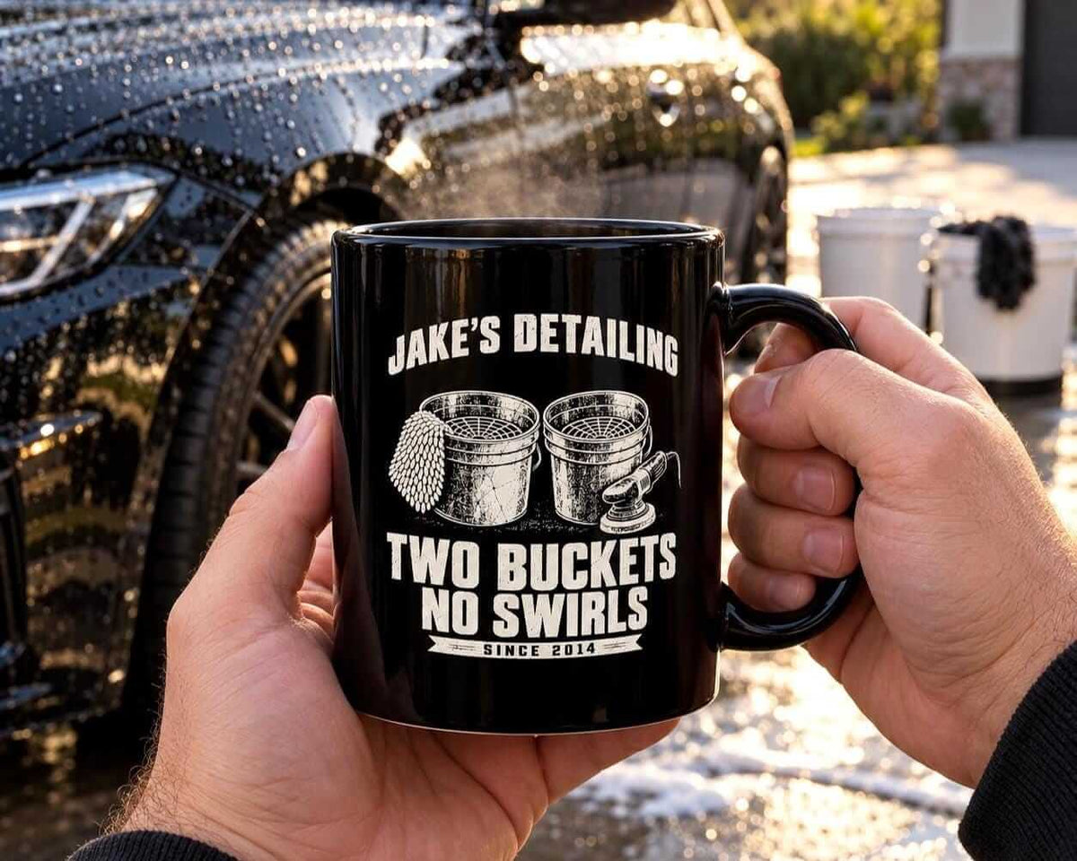 Hands holding the personalized Two Buckets No Swirls coffee mug in front of a freshly washed car
