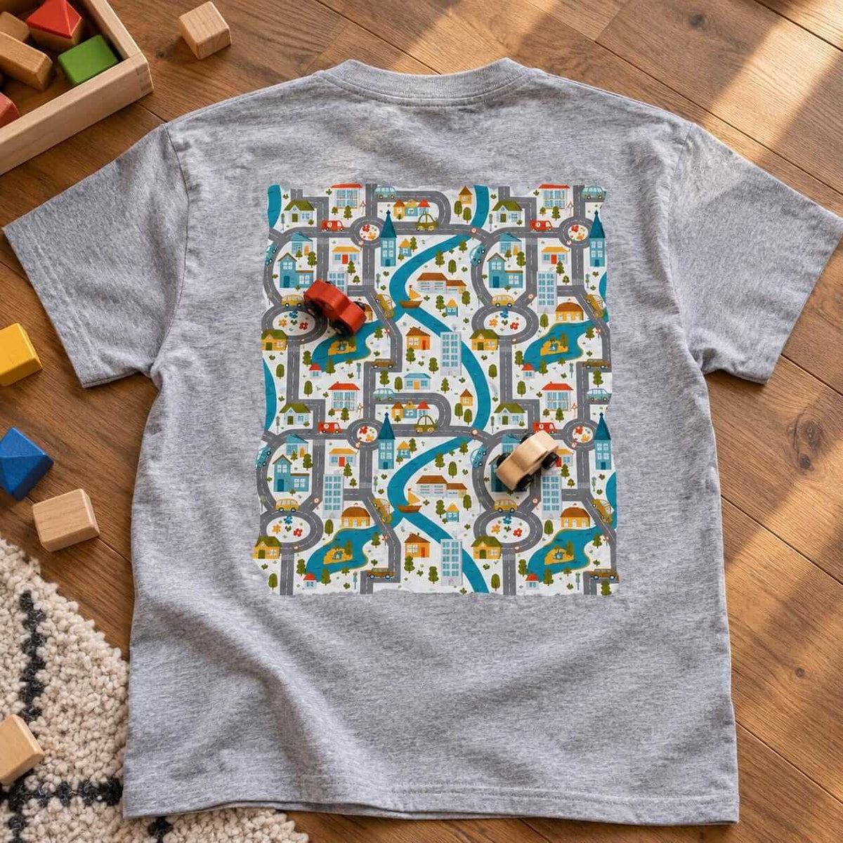Sport grey t-shirt with the road play mat back print on a wooden floor with toy cars and blocks