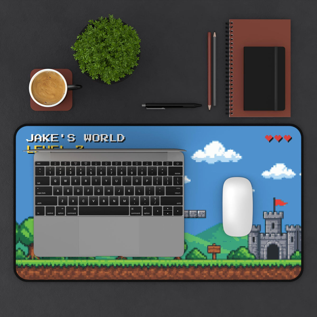 Pixel art desk mat with a laptop, mouse, coffee and notebook