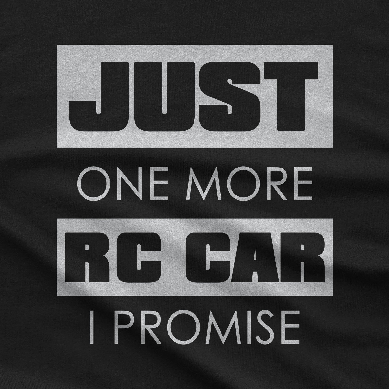 Close-up of the Just One More RC Car I Promise print on a black t-shirt
