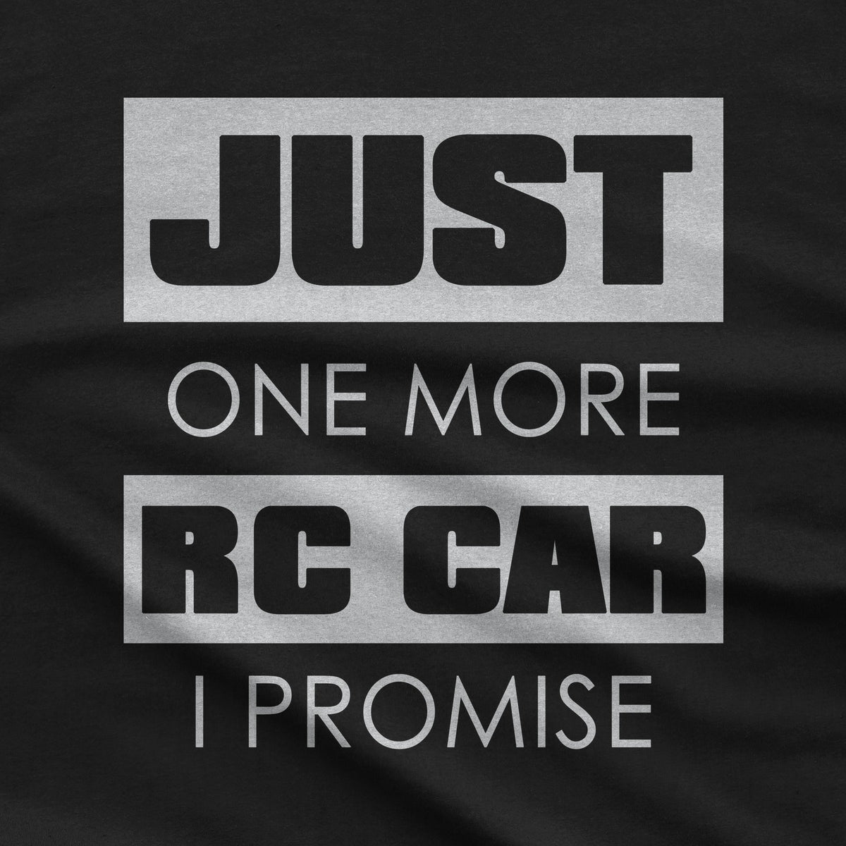 Close-up of the Just One More RC Car I Promise print on a black t-shirt