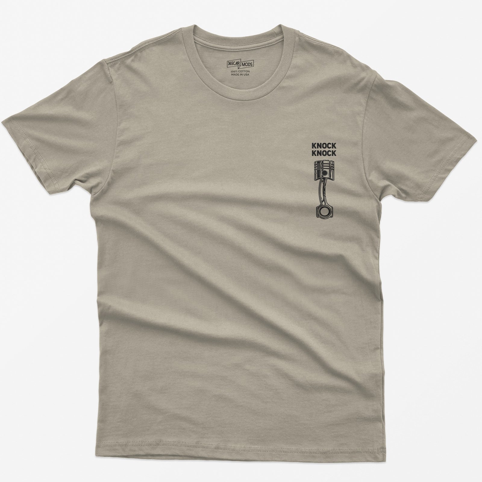 Sand t-shirt with Knock Knock text above a white line-art piston and connecting rod with a damaged crown