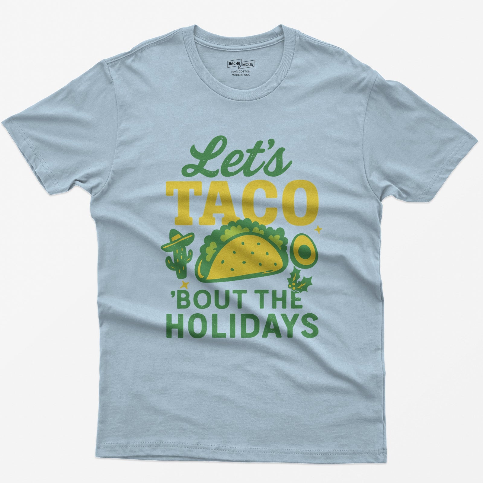Light Blue t-shirt with Let's Taco Bout The Holidays in green and yellow, with a taco, a cactus in a sombrero, avocado and holly