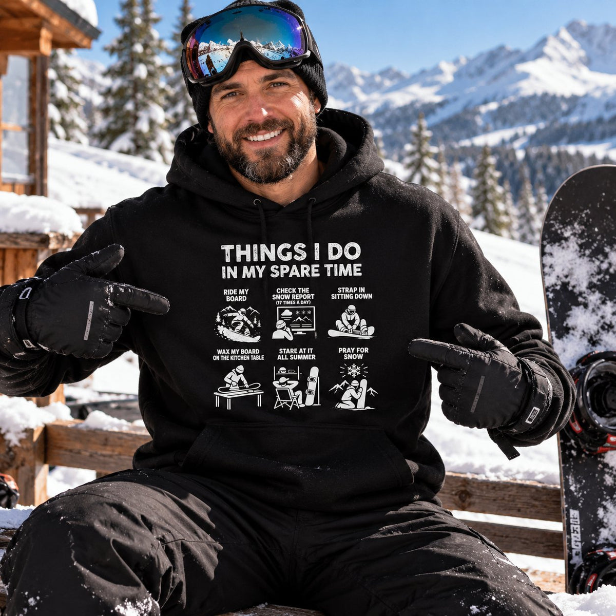 Snowboarder in the black Things I Do In My Spare Time snowboard hoodie at a mountain lodge