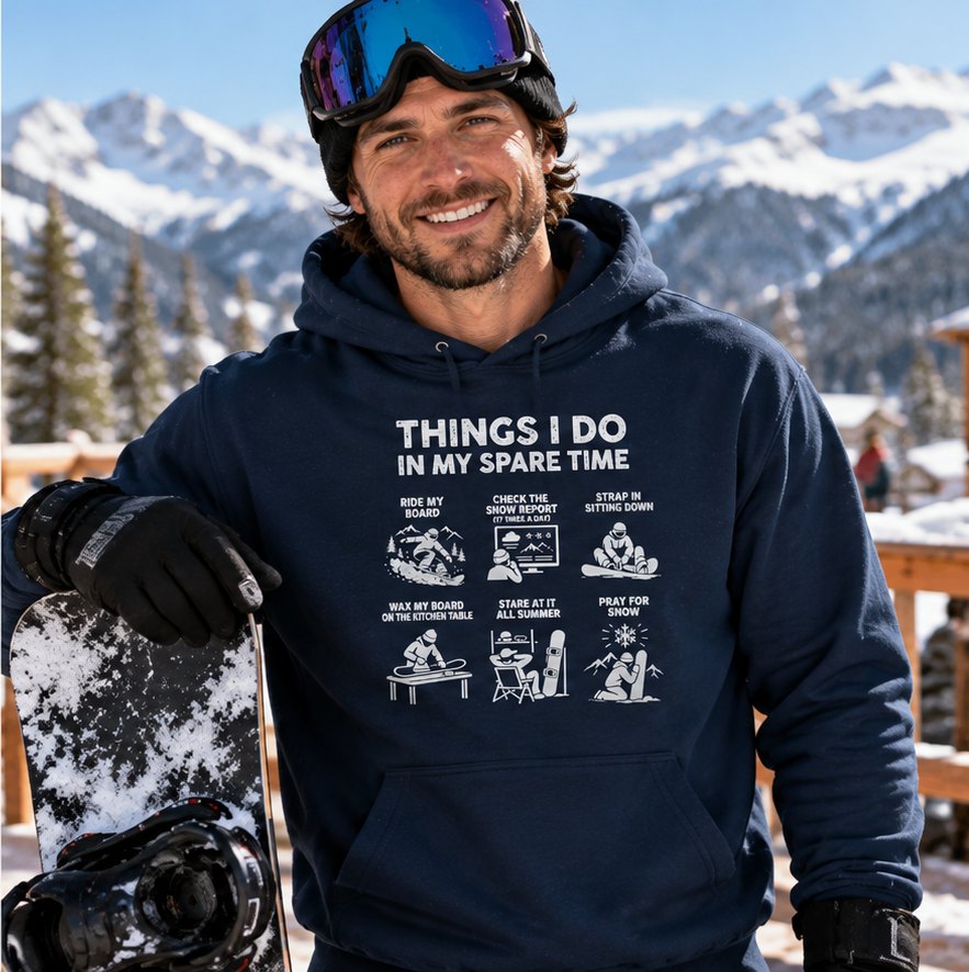 Snowboarder in the navy hoodie with his board on a snowy mountain deck
