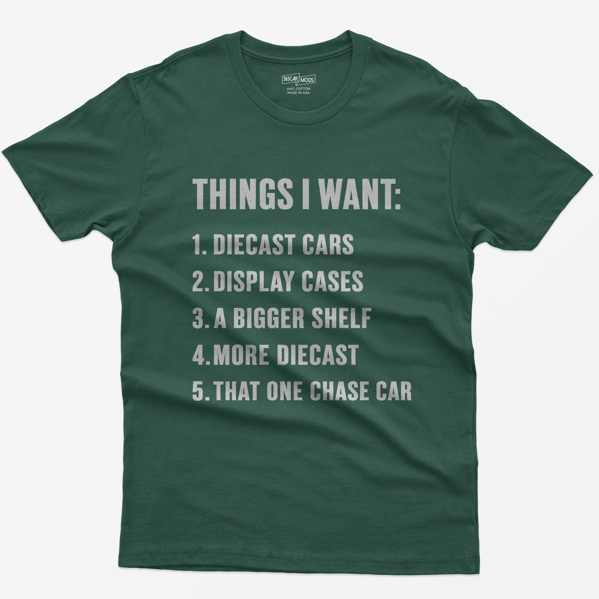Forest Green t-shirt with white block text Things I Want list: diecast cars, display cases, a bigger shelf, that one chase car