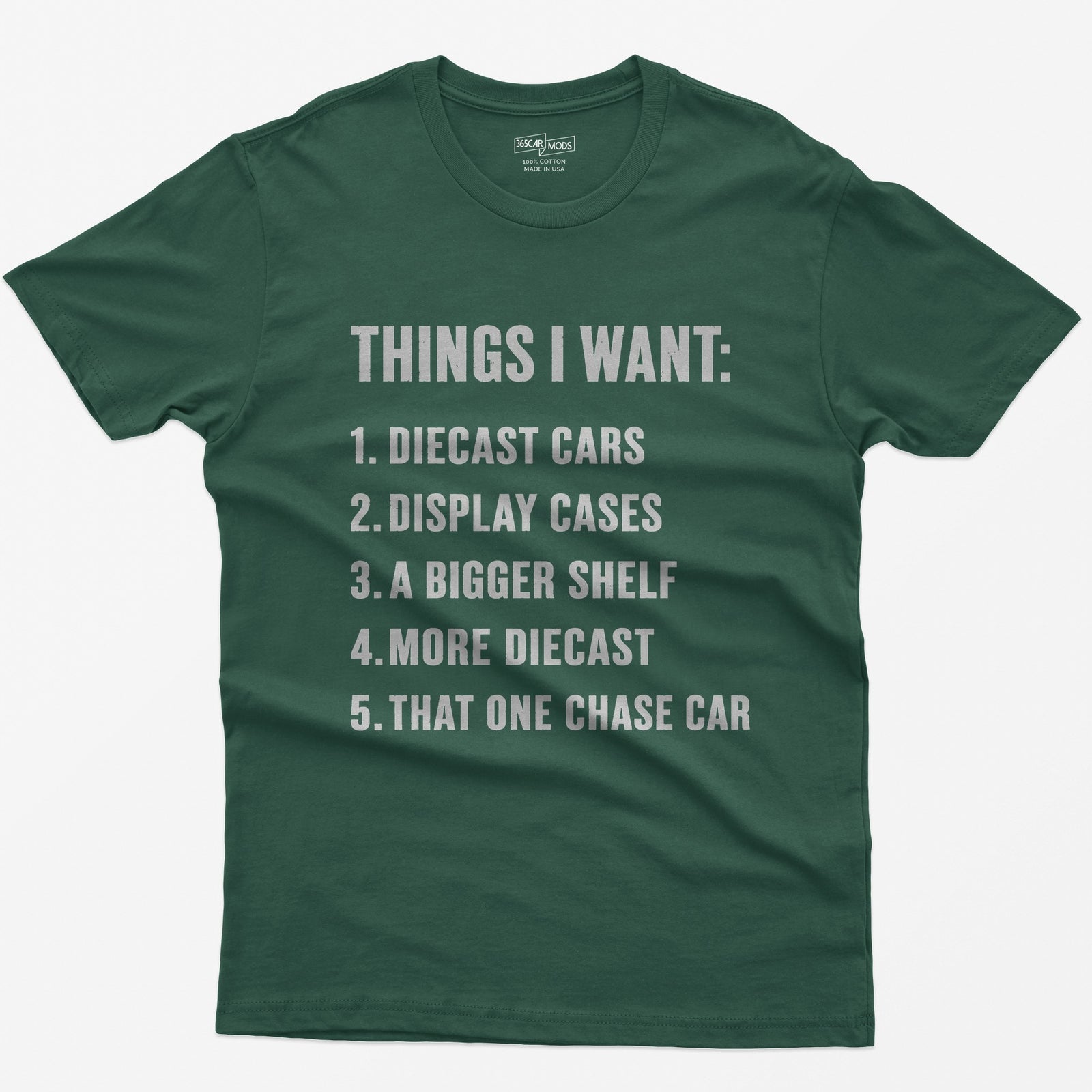Forest Green t-shirt with white block text Things I Want list: diecast cars, display cases, a bigger shelf, that one chase car