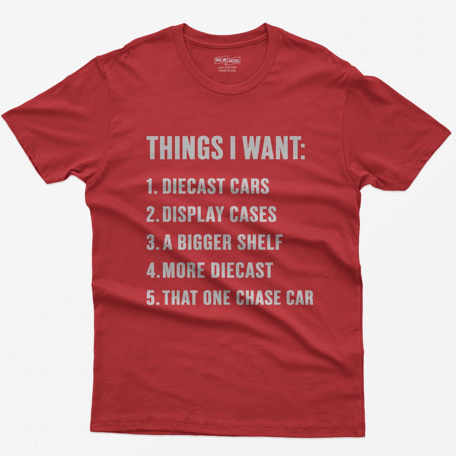Red t-shirt with white block text Things I Want list: diecast cars, display cases, a bigger shelf, that one chase car